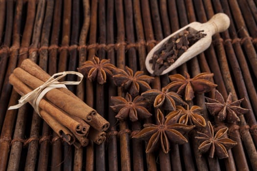 Cinnamon sticks with star shape anis on dark wood background