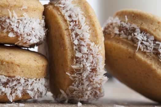 Small round cocnut cookies clos-up on brown wood