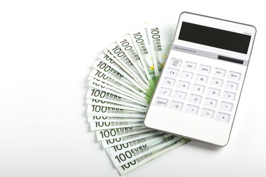 One hundred Euro banknotes with white calculator isolated on white background