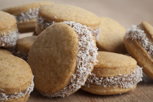 Small round cocnut cookies clos-up on brown wood 