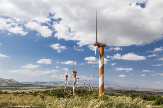 Orange windmill   on blue sky background with white clouds