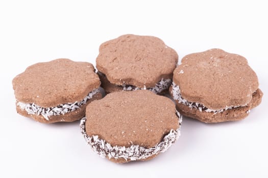 Brown star shape small coconut cookies isolated on white
