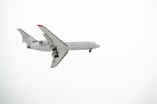 Aircraft with landing gear isolated on white background.