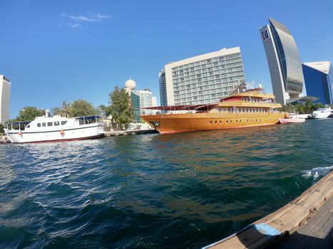 Skyline View of Dubai Creek with Traditional Fishing Boats and Buildings. Located in the Gulf Of Dubai.
