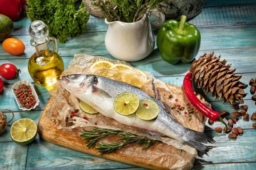 Fish and a bottle of oil on an old wooden desk