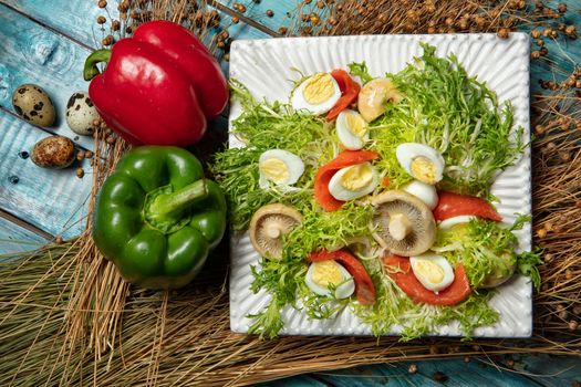 Salad with mushrooms and vegetables on an old wooden desk