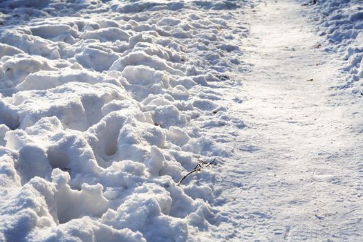 Winter background with footpath across snow