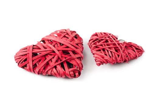 Two red hearts made of straw isolated on white, bigger and smaller one