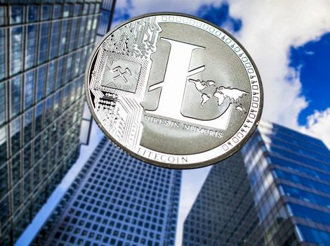 litecoin agains skyscrapers - futuristic smart city - cryptocurrency concept