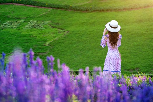 Beautiful woman on a flower garden.