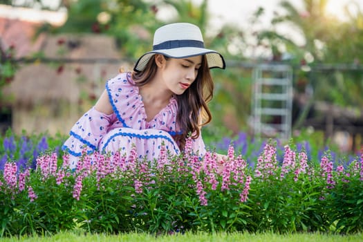 Beautiful woman on a flower garden.
