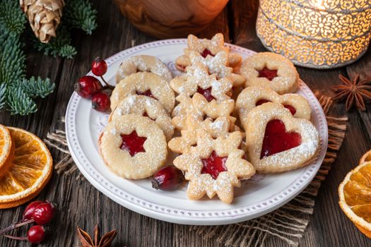Traditional Linzer Christmas cookies arranged on a plate on a rustic background