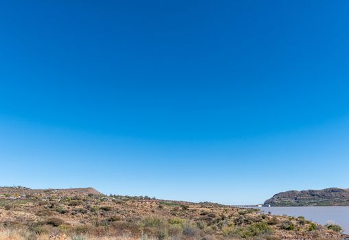 View of the the Vanderkloof town in the Northern Cape Province. The wall of the Vanderkloof Dam in the Orange River is visible in the back