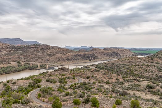 View downstream of the Vanderkloof Dam in the Orange River on the border of the Free State and Northern Cape Provinces. The single lane road bridge is visible
