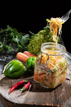 Cabbage and vegetables on an old wooden background
