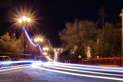 Evening view of the city of Khabarovsk in winter. Urban landscape. In the Windows of the houses light.