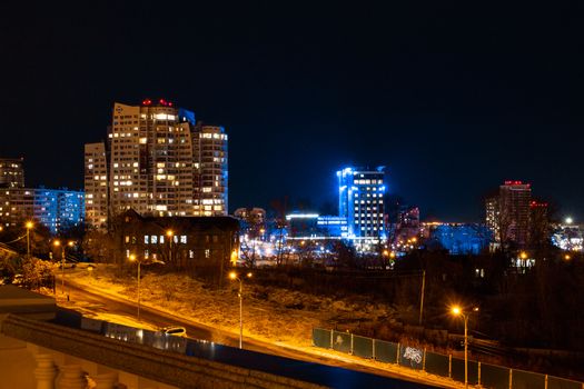Evening view of the city of Khabarovsk in winter. Urban landscape. In the Windows of the houses light.