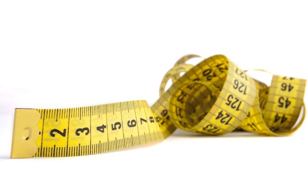 Yellow  measuring tape close-up isolated on white background