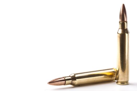 Two rifle bullets one vertical and the other orizontal isolated on white background
