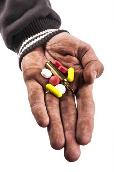 dirty human hand holding pills and bullet isolated on white background