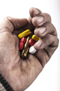 dirty human hand holding pills and bullet isolated on white background