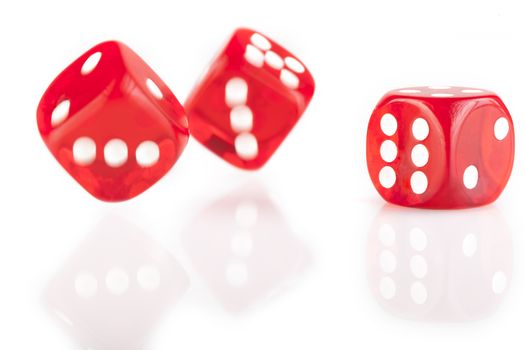 Three red dice isolated on white background with reflection