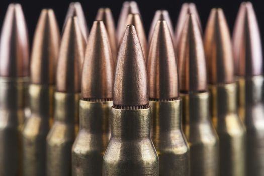 Rifle bullets close-up on black background