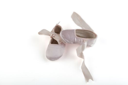 Pink small baby balerina shoes on white background