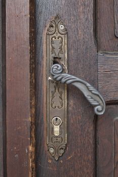 Old Door handle closeup on old brown door backround