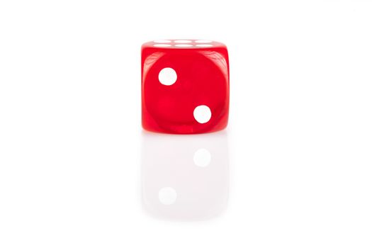 One  red dice isolated on white background with reflection