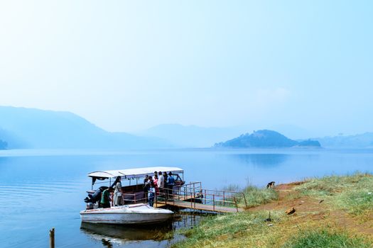 Umiam lake, shillong, Assam, India, December 15, 2017: Indian tourists people enjoying on travel holiday cruise boat tour.