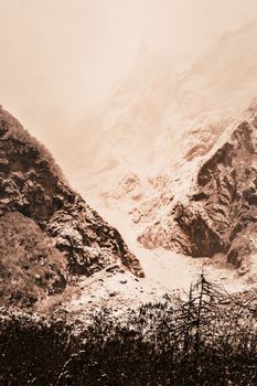 Snow-capped mountain peaks. Frozen landscape Himalayan mountain valley in winter. Snowy winter landscape with snow or hoarfrost covered fir trees.