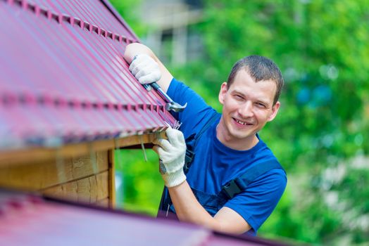 portrait of a successful experienced worker during roof repair