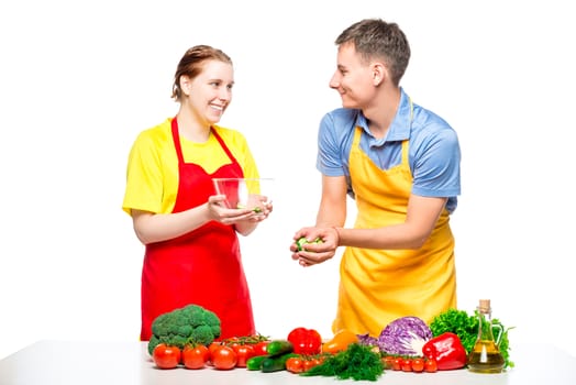 man and woman preparing healthy vegetable salad isolated on white background