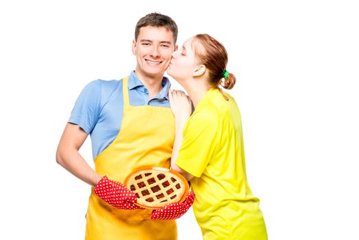 a man in an apron with a pie and her beloved wife, portrait on a white background