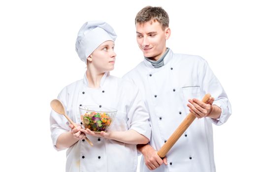 portrait of young professional chefs with a dish on a white background