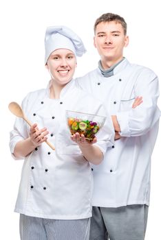 vertical portrait of successful cooks with salad on white background