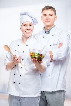 vertical portrait of successful chefs with salad