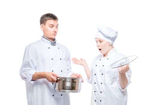 surprised cook looks at soup in a pan of another chef on a white background