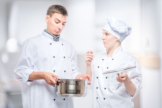chefs emotions regarding foul soup in a pan, a portrait against the background of the kitchen