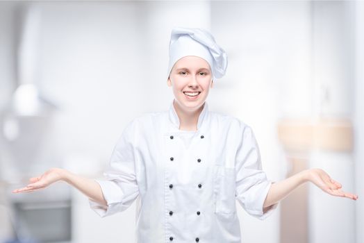 cheerful girl cook posing in the studio on the background of the kitchen