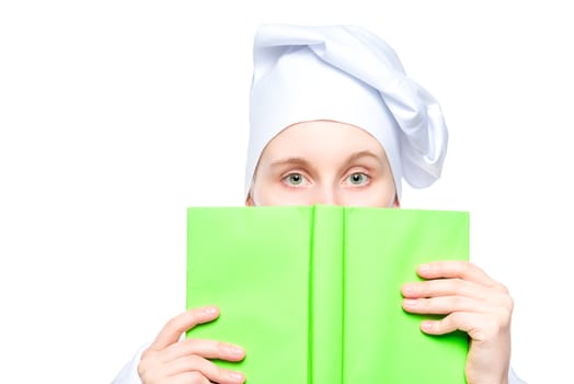 portrait of a cook in a cap close-up, face covered with a book of recipes concept photo isolated on white background