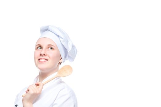 horizontal portrait of a happy dreaming cook with a wooden spoon on a white background, place for the inscription on the right