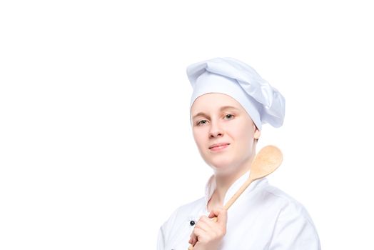 isolated portrait of a happy dreaming cook with a wooden spoon, a place for the inscription on the left