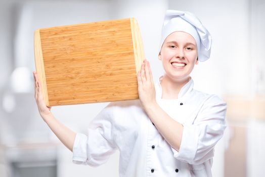 chef cook with wooden cutting board posing in the kitchen