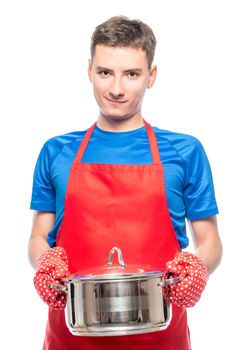 male cook in an apron holding a saucepan in his hands, portrait on a white background