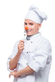 cooks with cherry tomato on a fork, shot on a white background in the studio