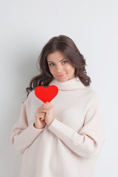 Woman holding paper heart shaped card . Valentine day concept . I'm looking waiting for partner ! Advertising people person relationship couple concept , white background