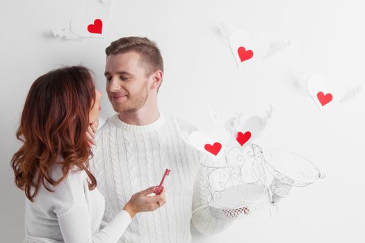Couple releasing love, man and woman open cage with winged hearts, valentines day concept