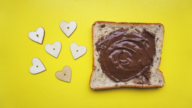 Toast on yellow background - sandwich with chocolate spread. Background for breakfast. View from above - Copy space photography.